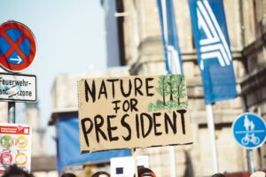 A man holding a sign that says nature for president, embracing SEO trends and generative AI for successful content creation in 2024.