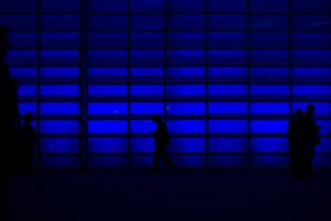 A group of people gathering in front of a blue wall during the revolutionizing document management event.