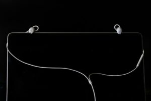 A laptop with earphones attached to it, showcasing AI's defining role in the digital age.