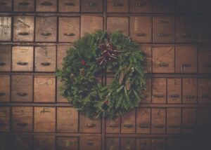 Boost Your Holiday Sales: A christmas wreath hangs on a wooden cabinet.