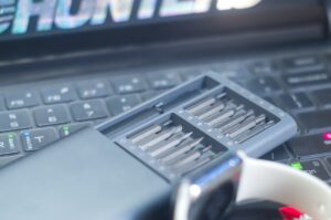 Discover the Top 50 AI Tools and Software Transforming Business Efficiency on a laptop with an apple watch.