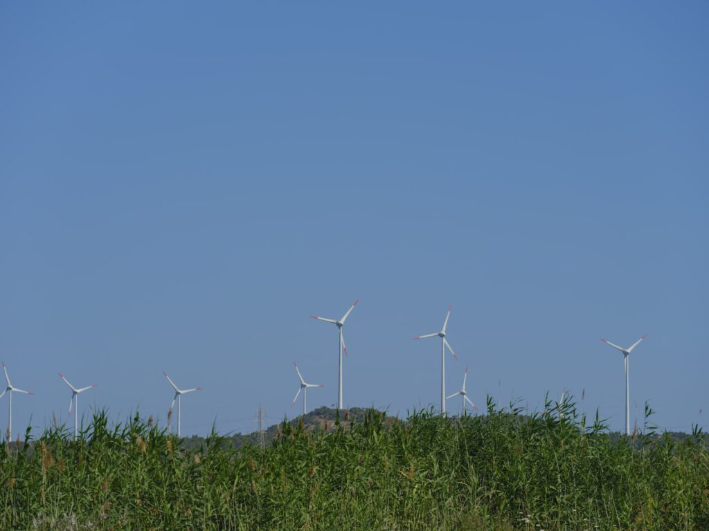 A group of wind turbines utilizing project management tracker templates in a field.