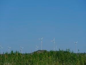 A group of wind turbines utilizing project management tracker templates in a field.