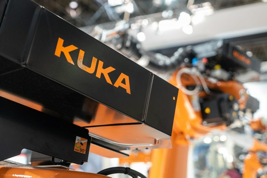 An orange KUKA robot.
