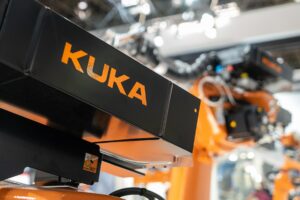 An orange KUKA robot.