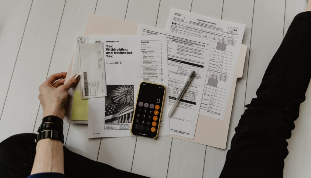 A person studying financial documents at a table.