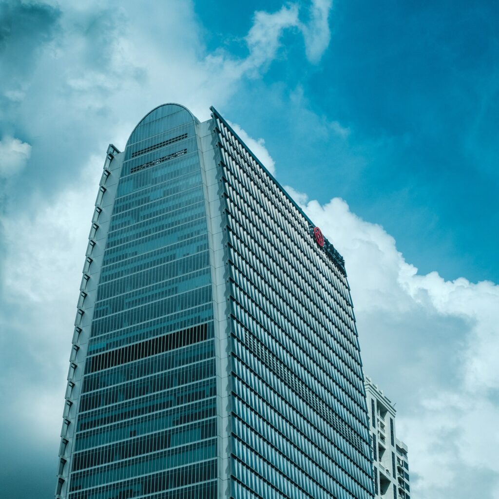A towering skyscraper piercing through a hazy atmosphere.