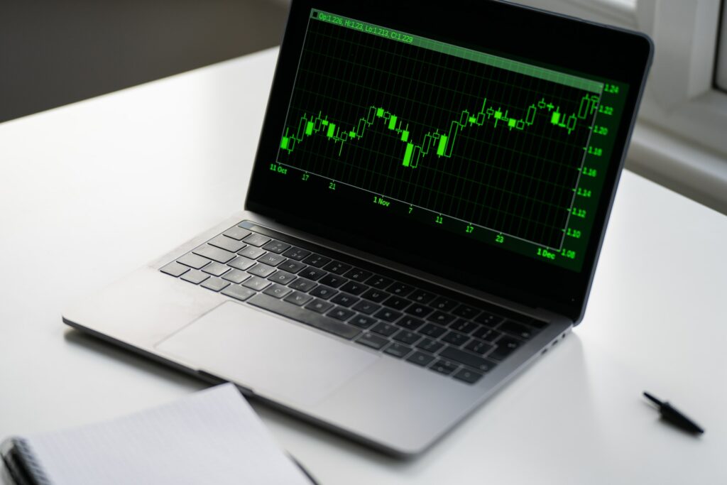 A laptop computer displaying a detailed stock chart, providing a comprehensive overview of asset management.