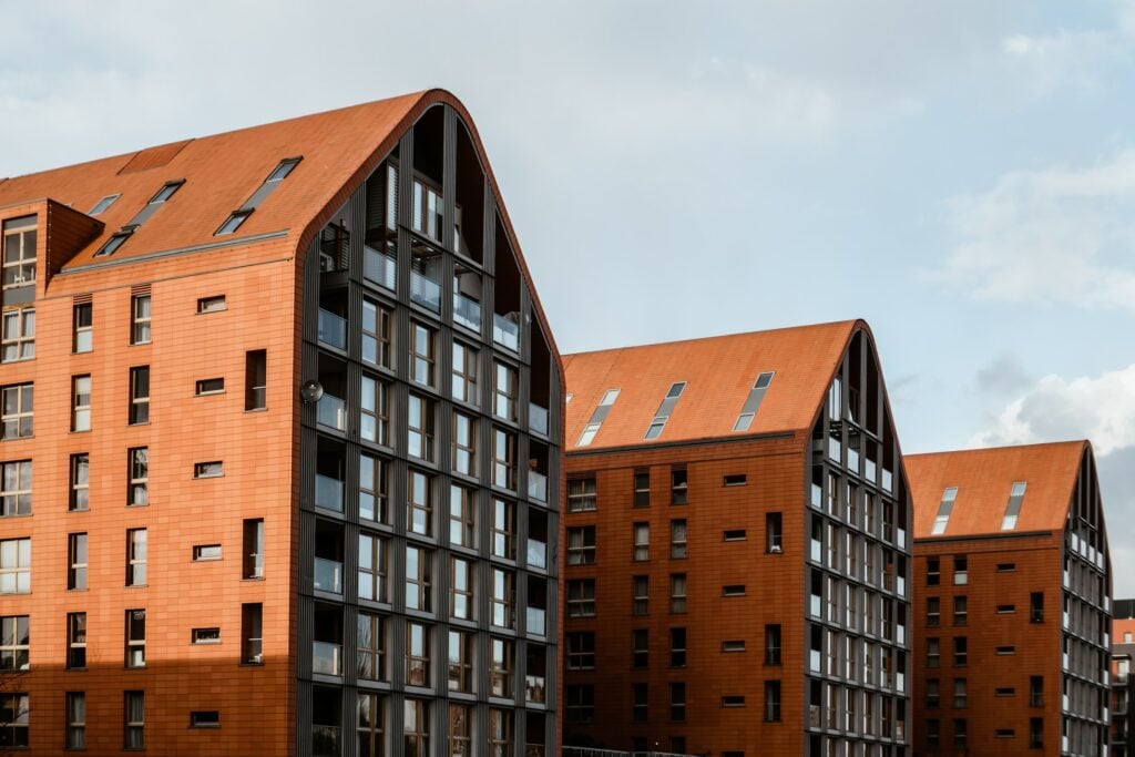 A row of red brick buildings in a community housing development.