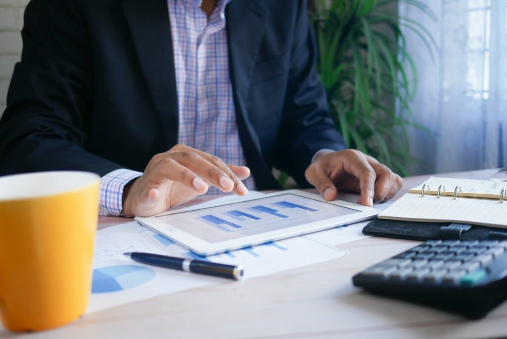 An efficient businessman utilizing a tablet for content analysis at his desk.