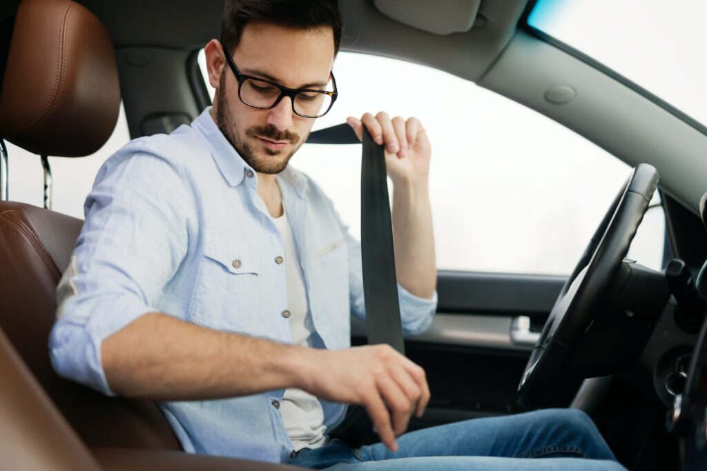 A man is sitting in the back seat of a car, while wondering about CTP Insurance.