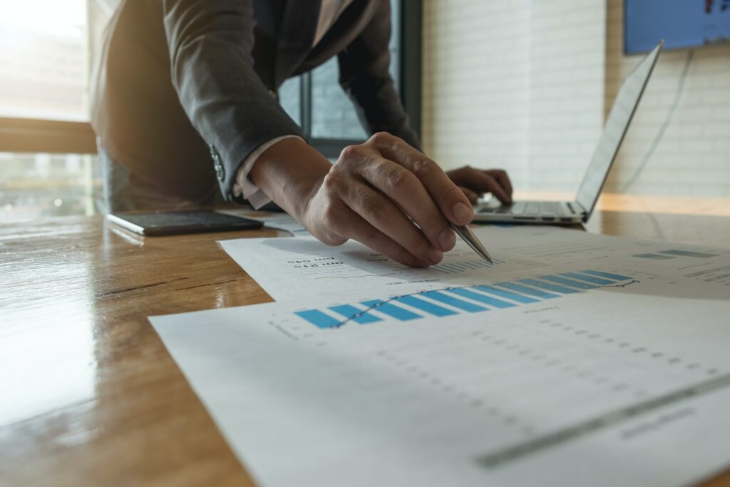 A data-driven businessman is using predictive analytics to write on a piece of paper, making informed decisions for the future.