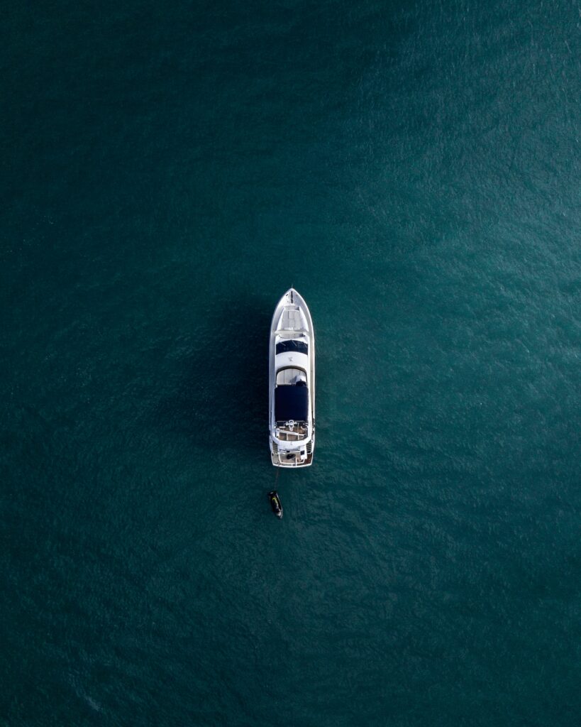 An aerial view of a boat in the ocean showcasing subtle luxury and understated opulence.