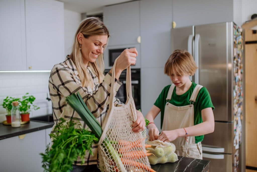 A Mother And Son Are Preparing Sustainable And Healthy Vegetables In The Kitchen.